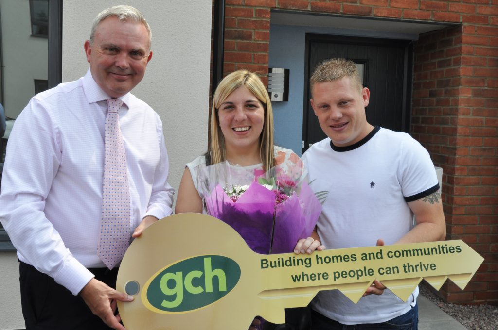 Ashley Green presenting flowers to tenants at Matson Avenue