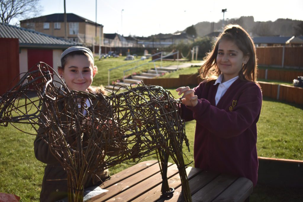 Pupils from Robinswood School making a wicker sheep