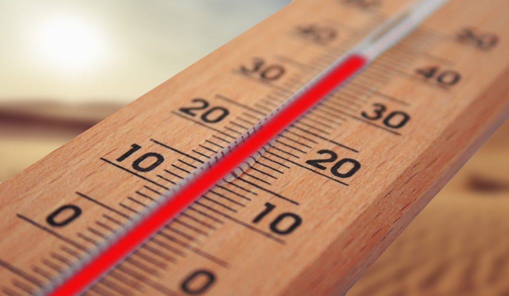 A picture of an outdoor thermometer with a high temperature