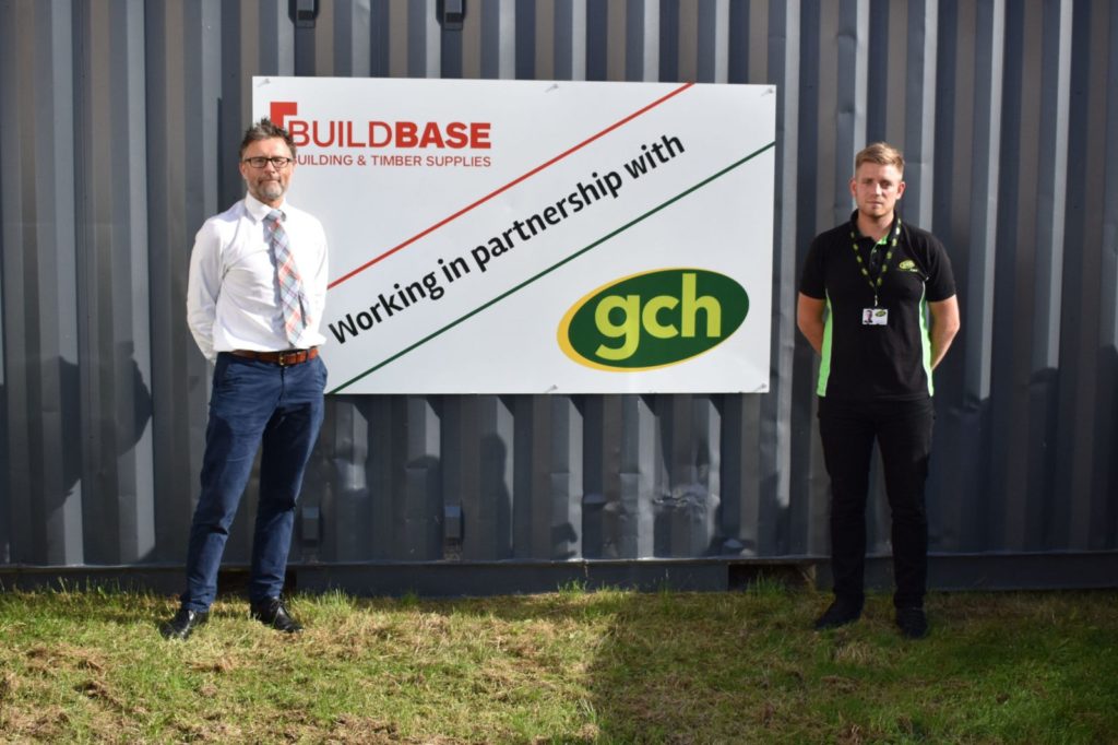 Builbase and GCH representatives stood next to store