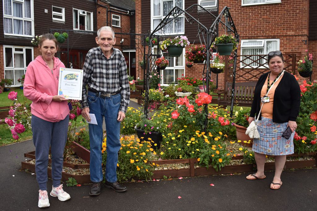 Mr Thomas, his daughter and Housing Officer Amanda stood in garden