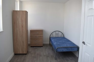 Wardrobe, unit and bed in bedroom at Burleigh House