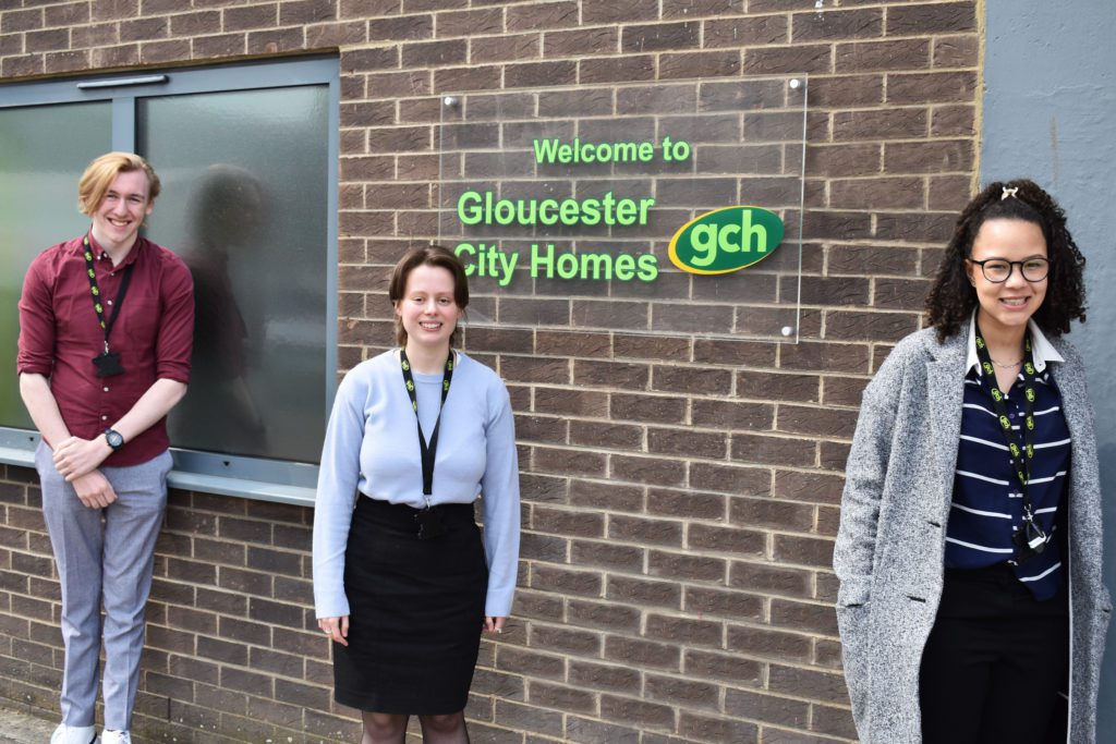 Sam, Maddie and Bekah stood next to GCH sign on wall