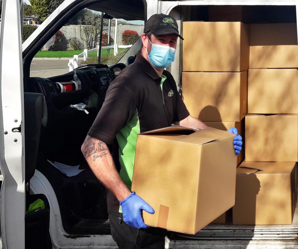 Sam unloading boxes from van