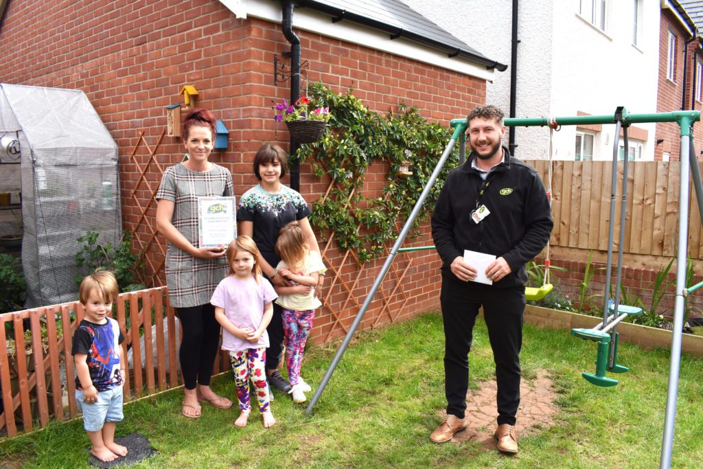 Garden Competition Runner Up Marissa with her children and Housing Officer David