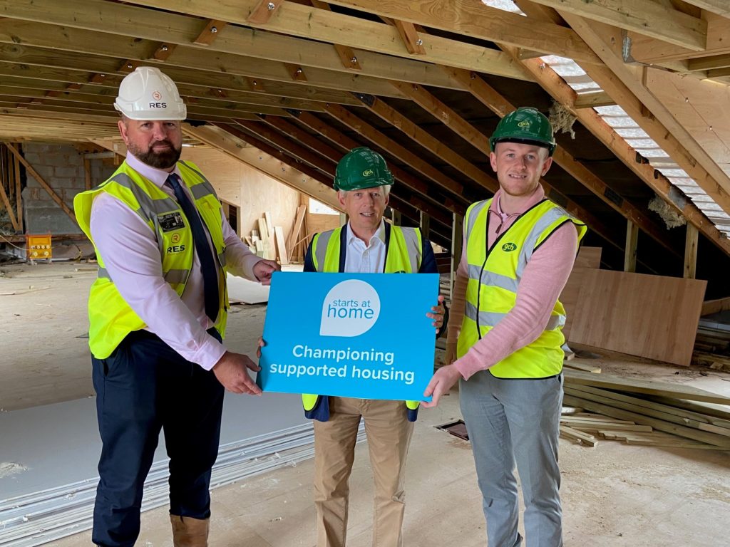 MP Richard Graham on site at new Homeless Accommodation Olympus House, holding a ‘Starts at Home’ Sign in Support of the Campaign