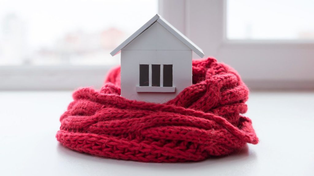 Little house wrapped in warm red scarf