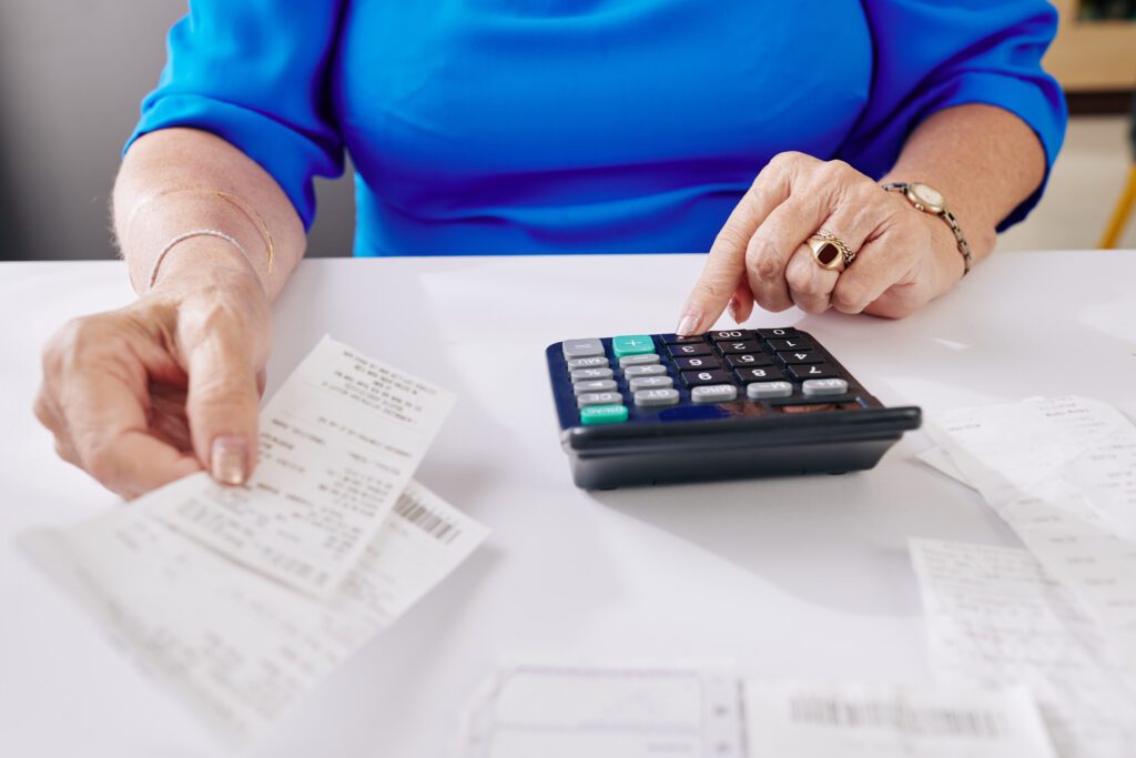 Aged woman paying bills