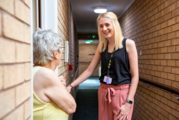 Laura, a member of GCH staff talking to resident at their door