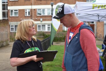 A member of GCH staff conducting a survey with a tenant