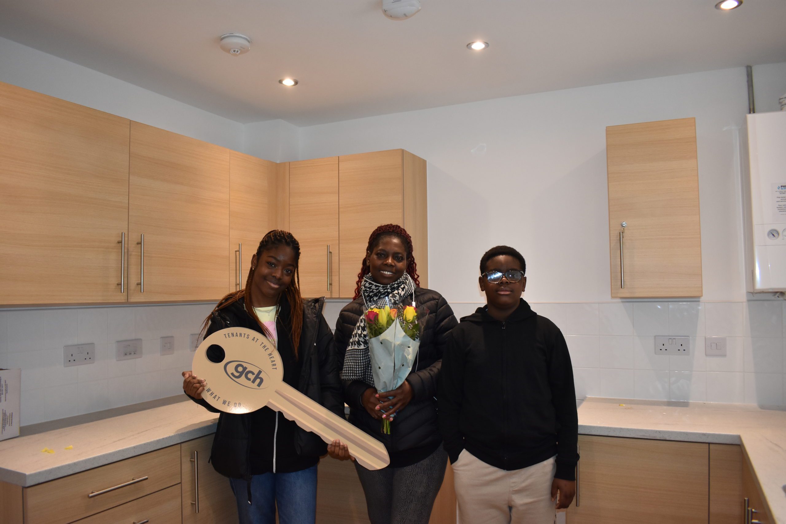 a family of three in their new kitchen
