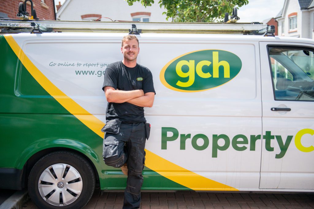Maintenance engineer in front of GCH Propertycare van