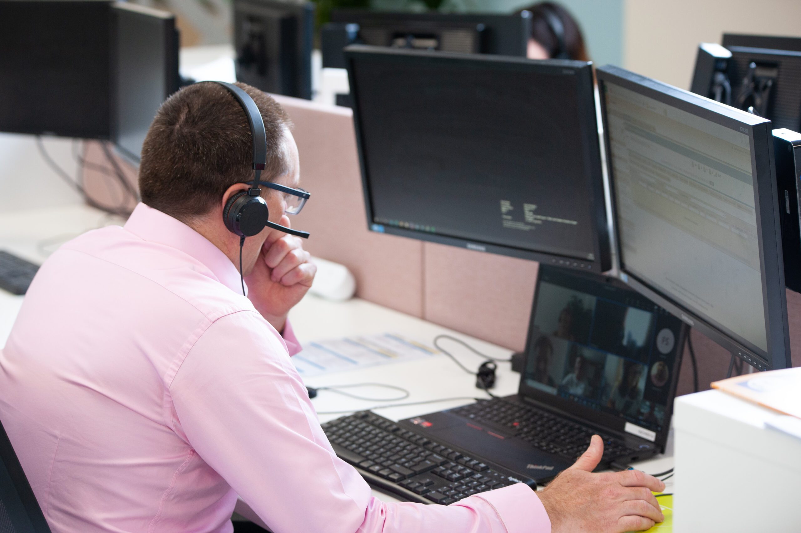 Customer Experience Advisor in front of computer