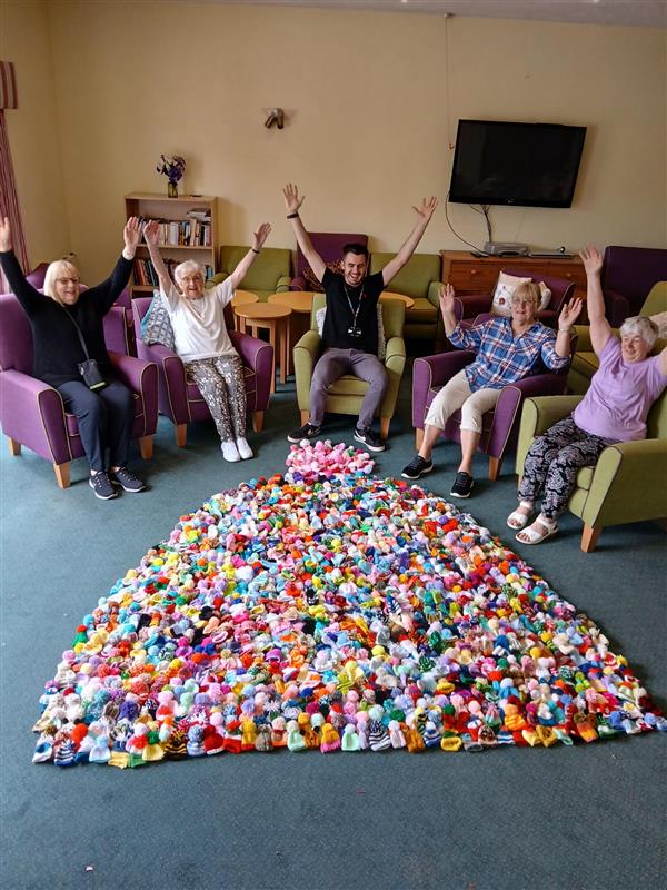 Customers and GCH colleagues celebrate their efforts for the 2025 Age UK Gloucestershire Big Knit campaign