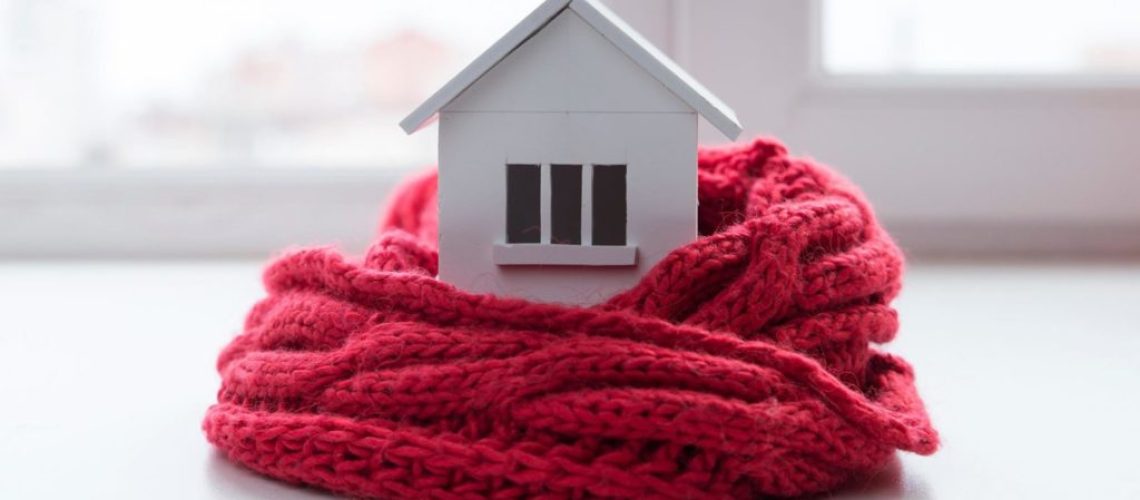 Little house wrapped in warm red scarf