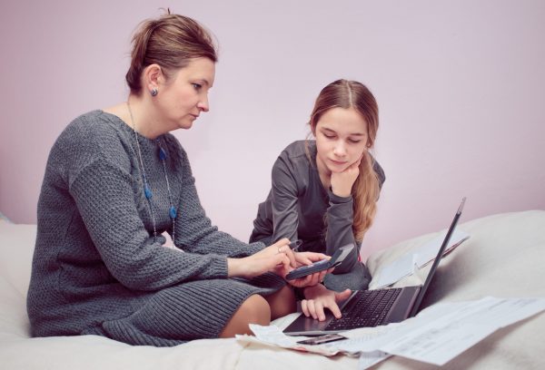 woman and her daughter planning budget at home